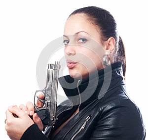 Beautiful girl in black jacket and beretta gun in her hands photo