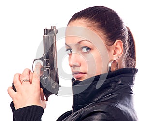 Beautiful girl in black leather jacket holding gun