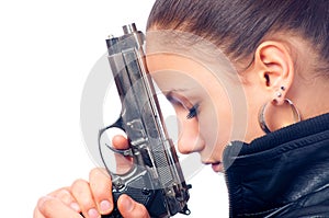Beautiful girl in black leather jacket holding gun