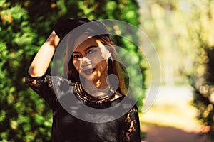 Beautiful girl in black vintage dress and hand glove. Woman in retro dress. Retro fashion. Red lips