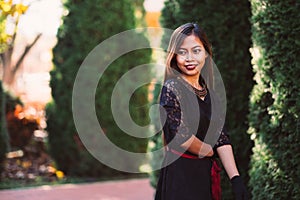 Beautiful girl in black vintage dress and hand glove. Woman in retro dress. Retro fashion. Red lips