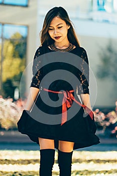 Beautiful girl in black vintage dress and hand glove. Woman in retro dress. Retro fashion. Red lips