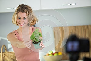 beautiful girl blogger with holding plant