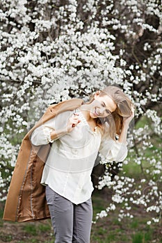 Beautiful girl in blossom garden on a spring day