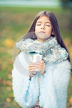 Beautiful girl with blue and fluffy scarf praying