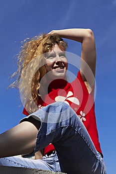 Beautiful girl on a blue sky background