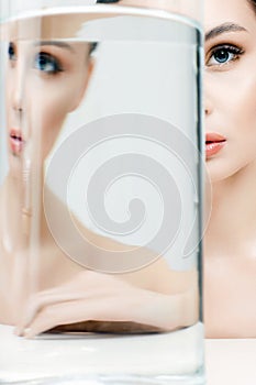 Beautiful girl in bottle with water. clean skin pretty young woman and glass