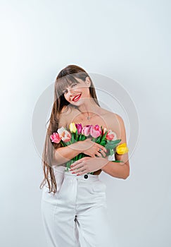 Beautiful girl with a bouquet of tulips isolated on white background