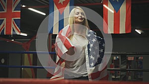 Beautiful girl boxer with an American flag in her hands