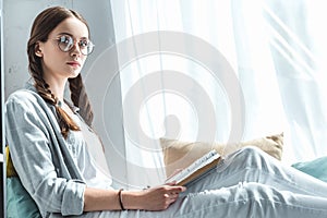 beautiful girl with braids reading book