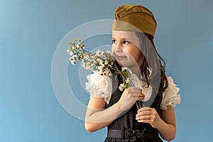 beautiful girl with a branch of a flowering tree to the theme of may 9, victory day