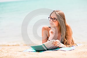 Beautiful girl breathing on the beach with the sea in the background photo