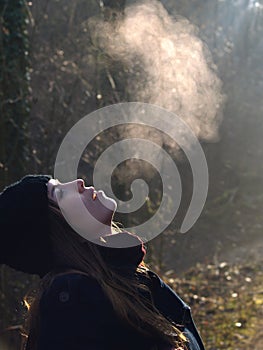 Beautiful girl breathing warm air