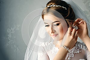 Beautiful girl, bride in a white dress on the background of the apartment. Wedding, bride`s gathering, family creation