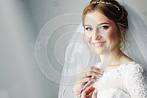 Beautiful girl, bride in a white dress on the background of the apartment. Wedding, bride`s gathering, family creation