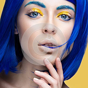 Beautiful girl in a bright blue wig in the style of cosplay and creative makeup. Beauty face. Art image. photo
