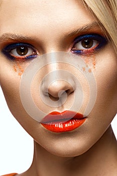 Beautiful girl with bright colored makeup and orange lips. Beauty face.