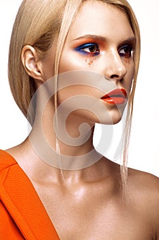 Beautiful girl with bright colored makeup and orange lips. Beauty face.