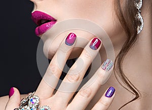 Beautiful girl with a bright evening make-up and pink manicure with rhinestones. Nail design. Beauty face. photo