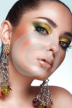 Beautiful girl with bright fashionable make-up and unusual accessories. Beauty face.