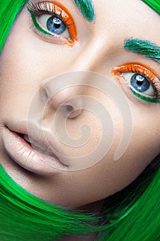 Beautiful girl in a bright green wig in the style of cosplay and creative makeup. Beauty face. Art image.