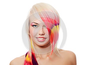 The beautiful girl with a bright make-up and multi-coloured strand in hair