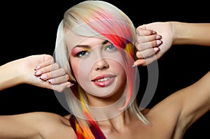 The beautiful girl with a bright make-up and multi-coloured strand in hair