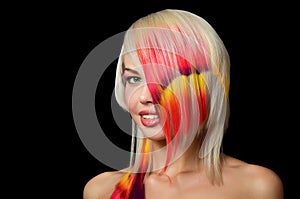 Beautiful girl with a bright make-up and multi-coloured strand in hair