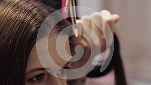 Beautiful girl with brown hair in a hair salon