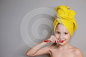 Beautiful girl brushes teeth; studio shot