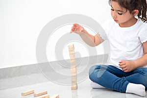 Beautiful girl builds a tower.