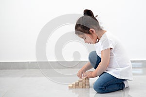 Beautiful girl builds a tower.