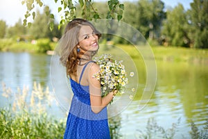 Beautiful girl with bunch of camomiles