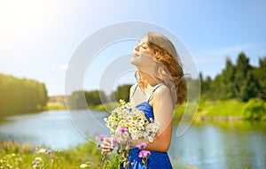 Beautiful girl with bunch of camomiles