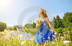 Beautiful girl with bunch of camomiles