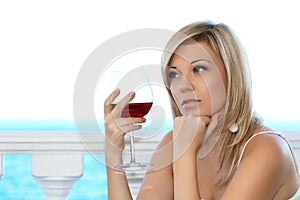 Beautiful girl in the cafe with a glass of red win