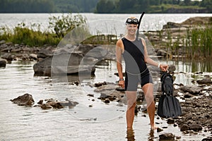 A beautiful girl in a calypso is snorkeling at the sea