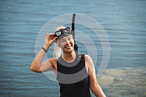 A beautiful girl in a calypso is snorkeling at the sea, photo portrait