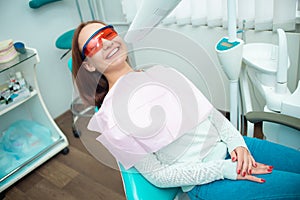 Beautiful girl in a chair at the dentist. Medical office. Dental examination