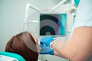 Beautiful girl in a chair at the dentist. Medical office. Dental examination