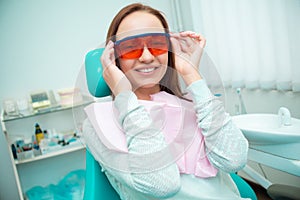 Beautiful girl in a chair at the dentist. Medical office. Dental examination
