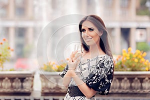 Beautiful Girl with Champagne Glass Celebrating by the Fountain