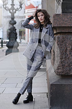 Beautiful girl in a checked pantsuit