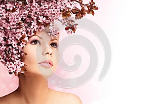 Beautiful Girl With Cherry Blossom isolated on white. Beauty