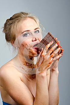 Beautiful girl with chocolate in the Studio