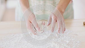 Beautiful girl clapping hands filled with flour