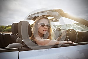 Beautiful girl in a classy car