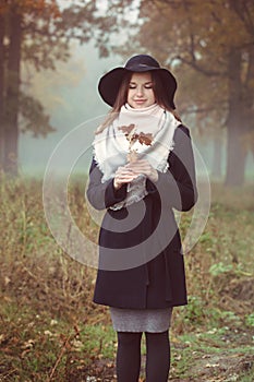 A beautiful girl in a coat and hat