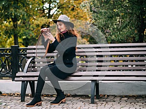 Beautiful girl in a coat and in a hat