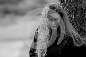 Beautiful girl in a coat in the woods on the mountain.